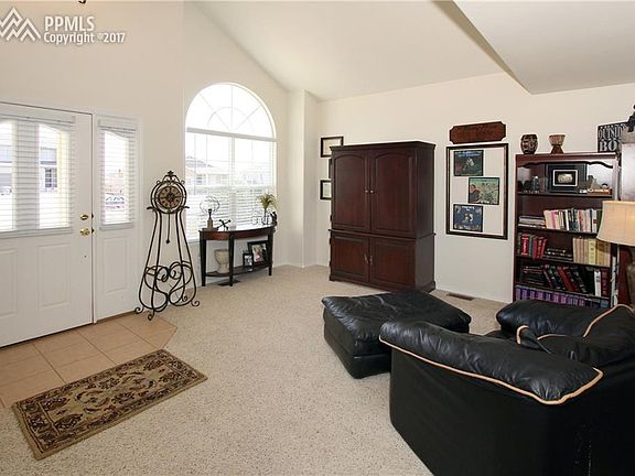 Living room with dramatic vaulted ceilings and large windows surrounding you in