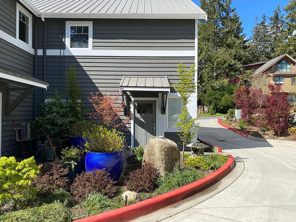 Welcome to 380 Ericksen Ave NE, Apartment #2. Looking from parking area to private entrance to Apartment #2