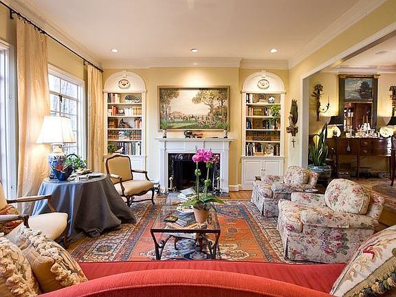 FORMAL LIVING ROOM W FIREPLACE FLANKED BY CUSTOM CABINETRY