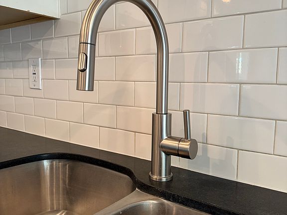 Home has all new, modern fixtures including kitchen faucet.