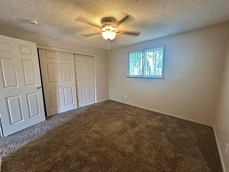 Bright and inviting bedroom with plush carpeting and ample closet space, perfect for relaxing and unwinding. Bright and inviting bedroom with plush carpeting and ample closet space, perfect for relaxing and unwinding.