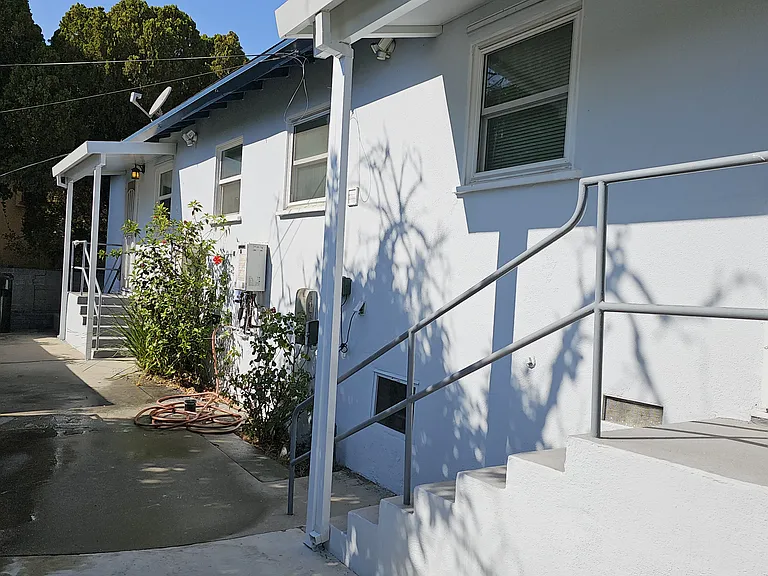 Stairs outside of rear door, looking towards rear area of adjacent duplex unit.