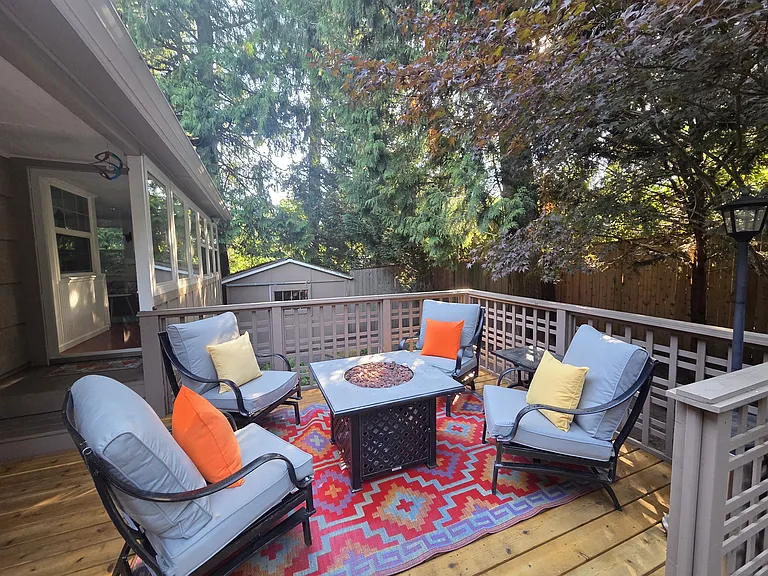 Just off the home, a warm and inviting fire-pit lounge awaits. This intimate social hub features plush seating arranged around a gas fire pit, perfect for unwinding on a cool evening.