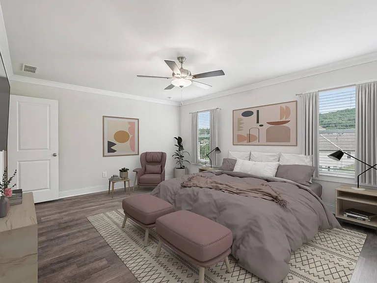 Primary bedroom with king size bed and large window letting in nice natural light.