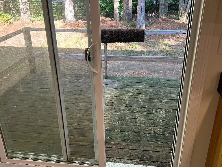 Private back deck off dining area sliding door leading to quiet back yard