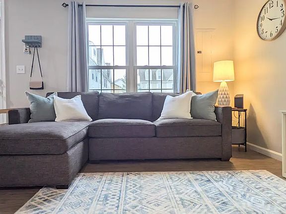 Light-filled living room with kids toys and books tucked away in the cabinet under the TV.