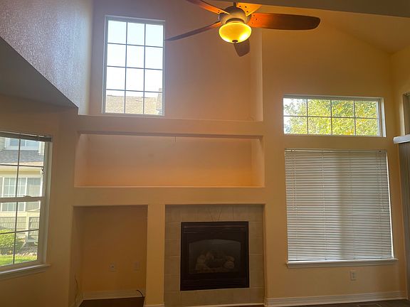 North-facing windows give indirect sunlight without heating up the room in the summer. A ceiling fan provides air circulation and general room lighting.