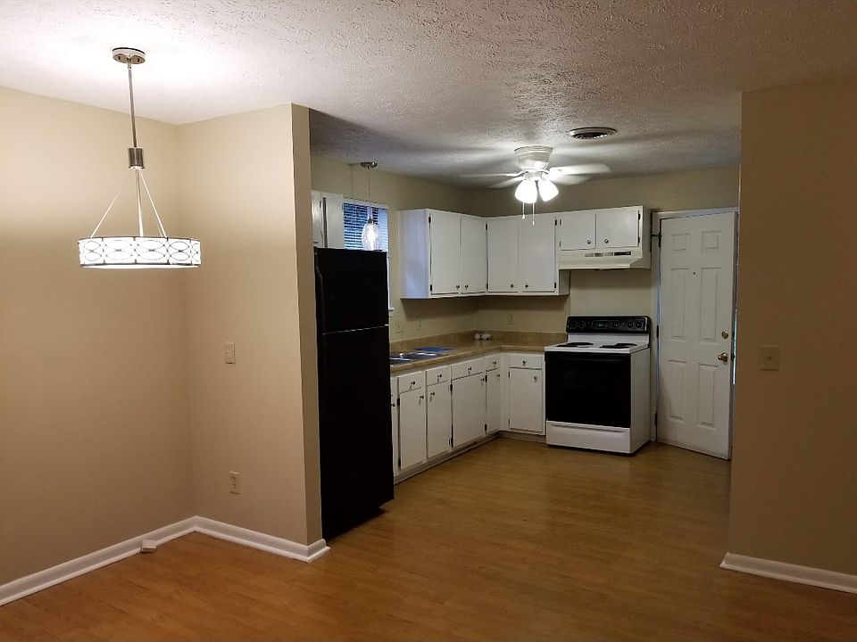 View from Living Room into kitchen. New chandelier for area above table or desk