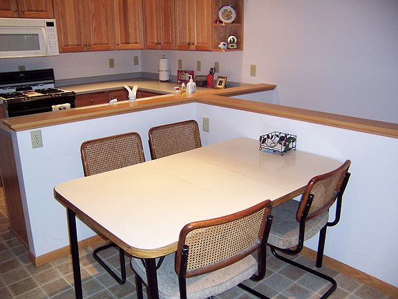Dining area has slider to the large deck and is open to the kitchen 