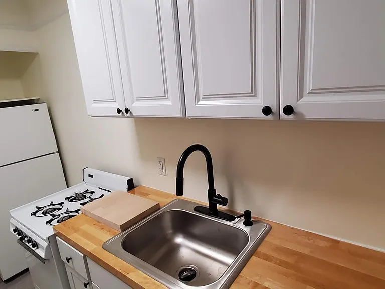 All the kitchen counters and cabinets, counters, and the sink are brand new. The stove/oven is gas.