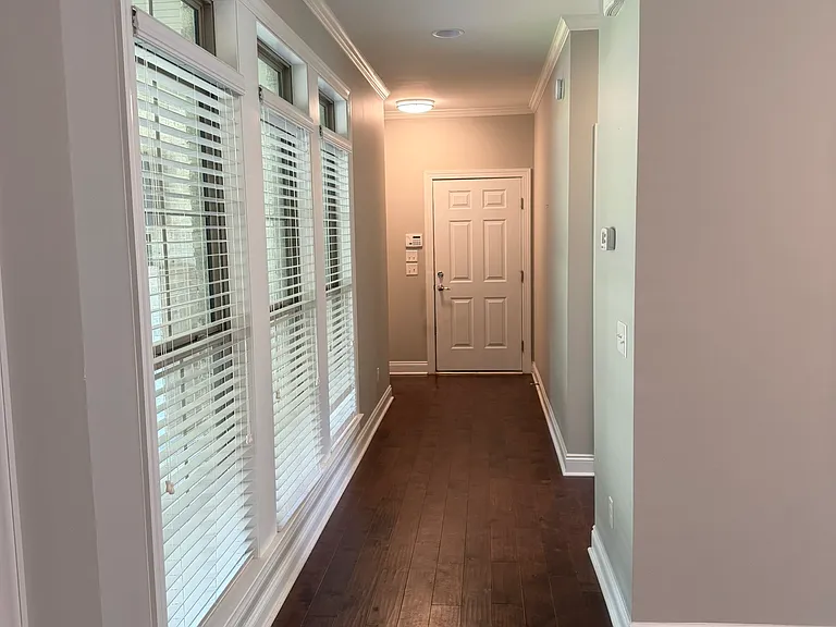 Hall to primary bedroom and garage