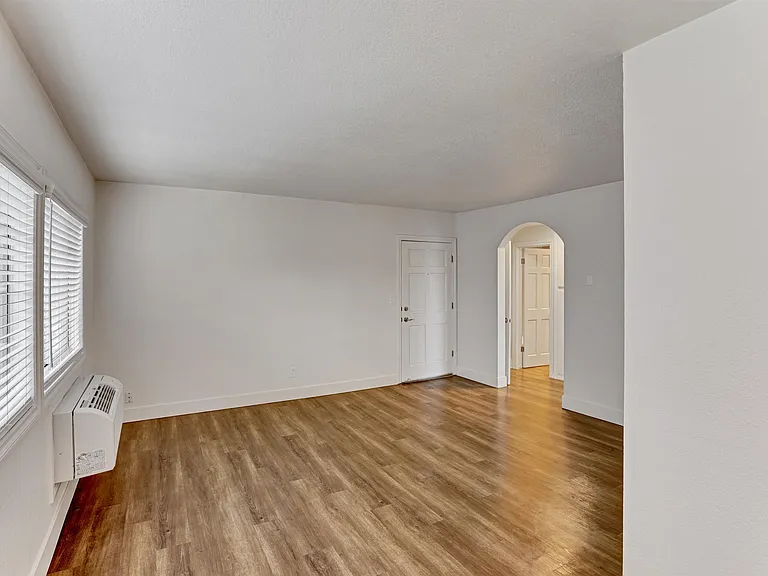 A room with wooden floors and white walls.