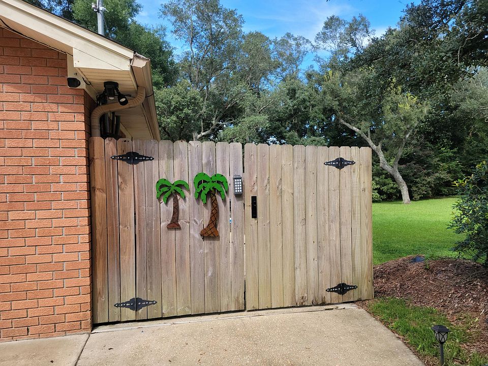 Park in front of the garage here & enter through the gate on the far right side of the house. There is no neighbor next door but the lot is privately owned and monitored. The parking space has a ring flood light with camera. Monitored as needed.