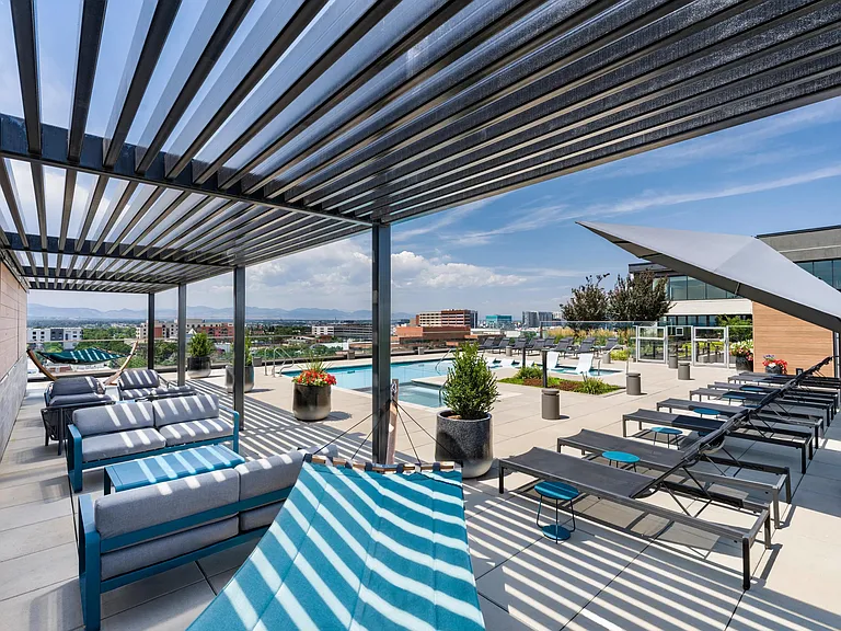 Poolside lounge with panoramic mountain views, shaded hammocks, and space to unwind above the city.