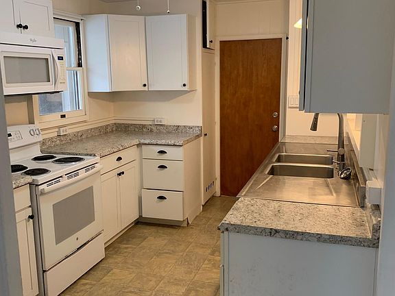 Kitchen; full sized electric range, wall mounted microwave, full sized refrigerator with ice maker and dishwasher.