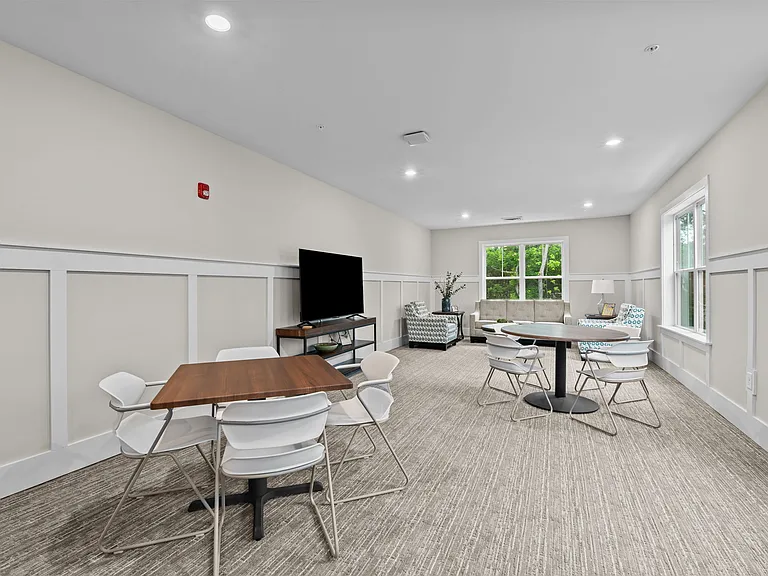 Active Adult conference room with tables and chairs and a television