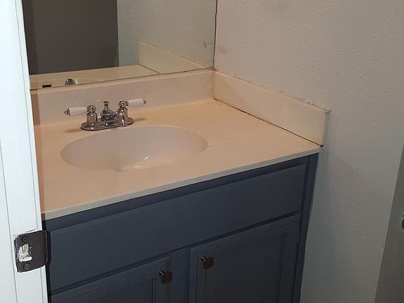 Half bath downstairs with vanity, storage, toilet.
