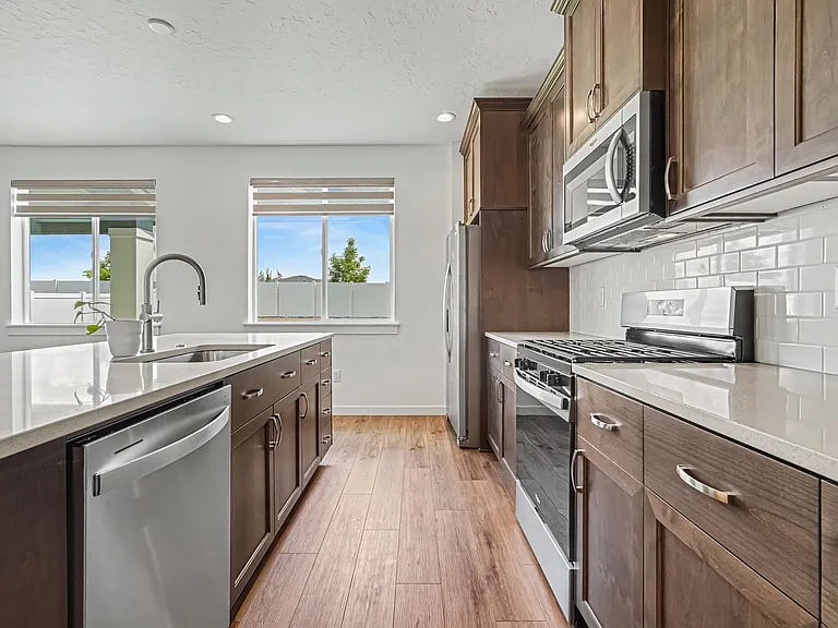 Kitchen with Gas Stove, Oven, Microwave and Refrigerator