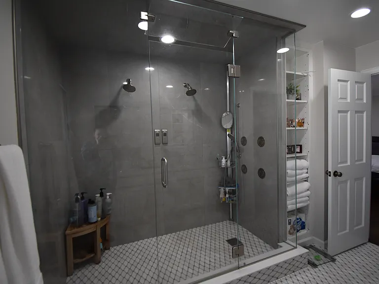 Primary bathroom shower with 3 shower heads and a 4-spray body system