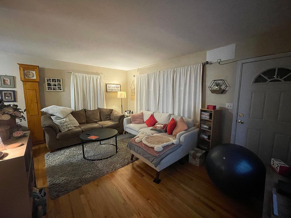 Living room (12x24) showing bay window and front door, facing southeast.
