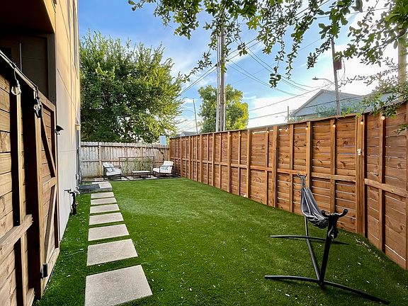 Recently installed pet-safe turf with two low-maintenance seating areas