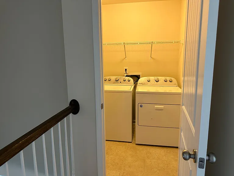 A view into the laundry room, the house comes with both the washer and the dryer.