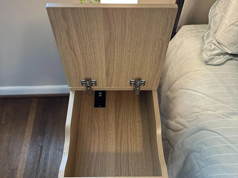 Touch-screen lamp with dimmed lighting options and bedside table with storage.