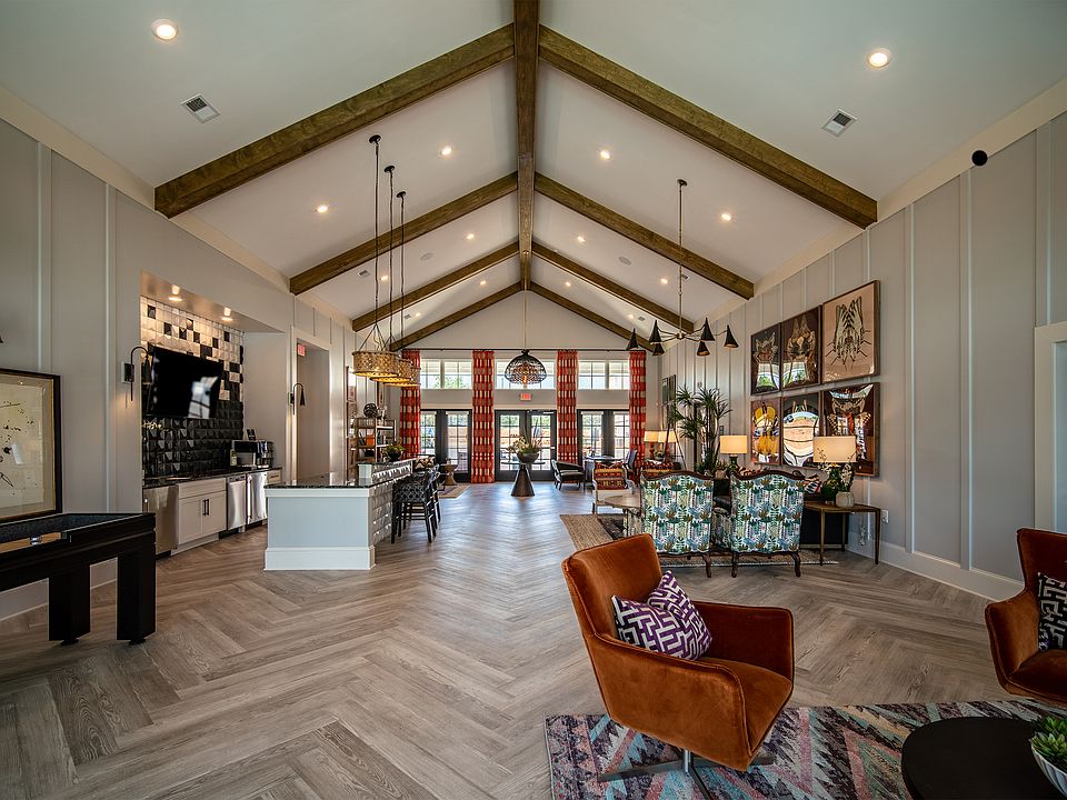 Chic and spacious clubhouse with vaulted ceilings, elegant decor, and abundant natural light.