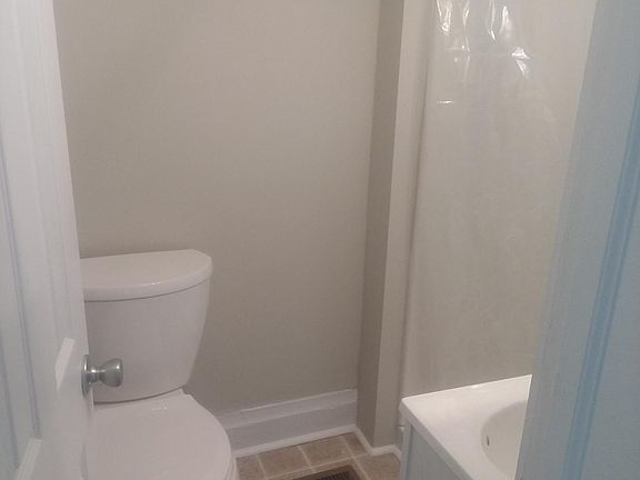 The bathroom has been completely refinished! New flooring, toilet, vanity, and shower enclosure.