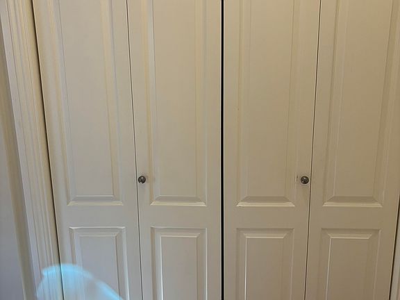 Laundry area behind folding doors