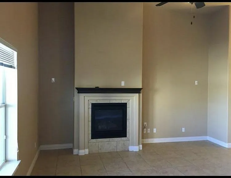 Living room area with fireplace and connections for entertainment center available.