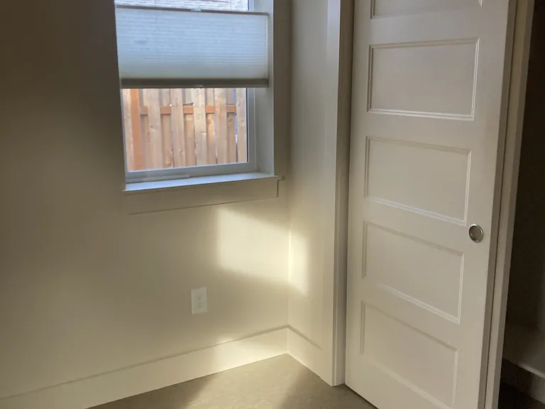 Bedroom has south and west facing windows with privacy and light. Flooring is new marmoleum.