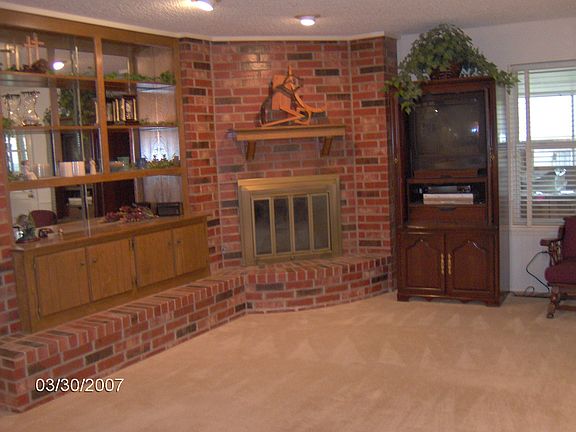 XL Family room with cozy fireplace & built in bookshelves.