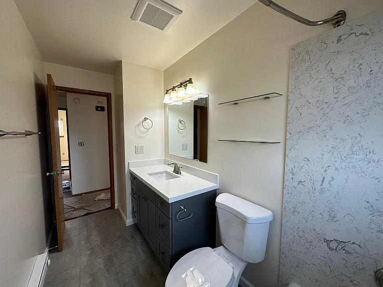 New full bath with Quartz counter and tub surround