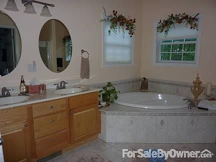 Master Bath
						:
						From the bedroom. Oak vanity w/double sink, whirlpool tub, view to wooded yard.