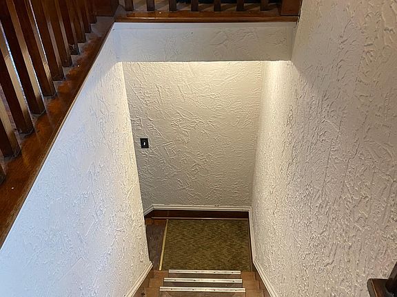 Descending stairway from upstairs apartment.