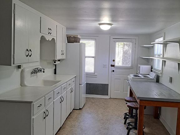 Kitchen with great storage. Eat in work area and table with stools.