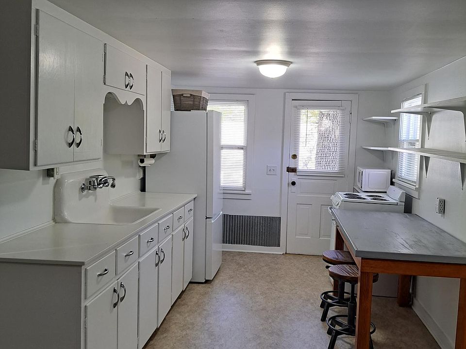 Kitchen with great storage. Eat in work area and table with stools.