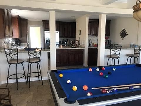 Dining room and shows some of kitchen area, wet bar. Also se