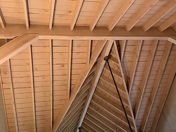 Vaulted ceilings with open rafters and exposed beams.