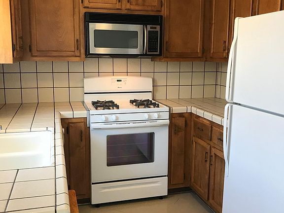 A dishwasher is under the counter next to the sink.