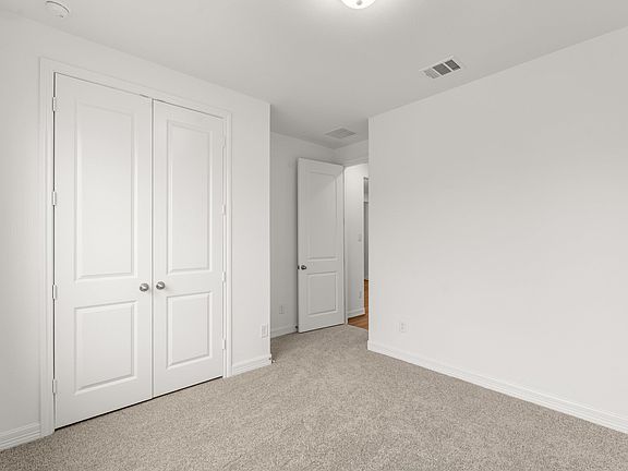An additional view of the second bedroom and closet.