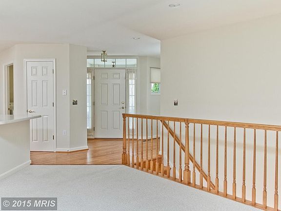 Foyer w/ oak flooring; Open railing to lower level