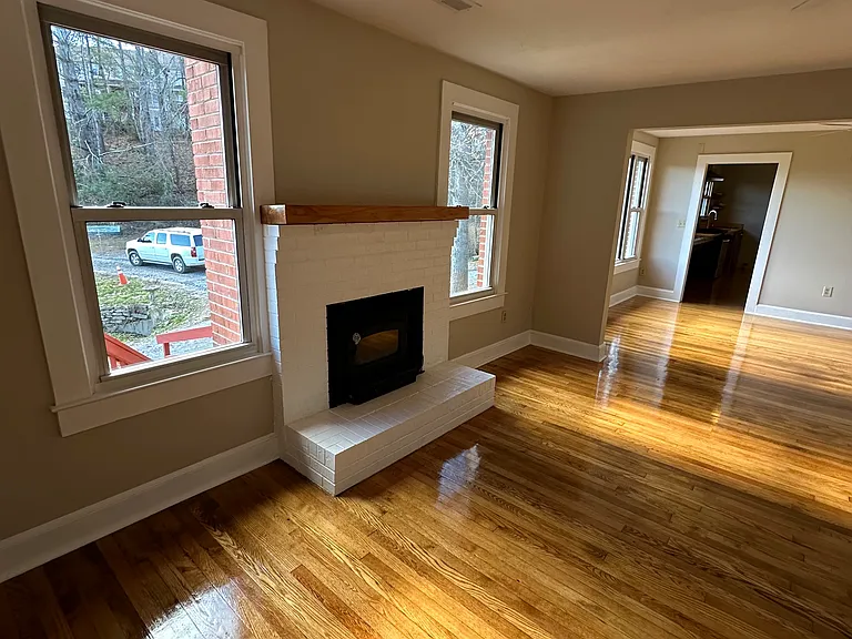 Wood burning fireplace on left.