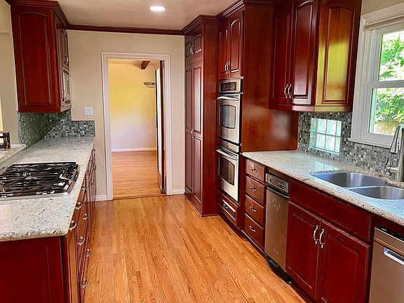 Beautiful wooden cabinets & granite countertops in kitchen