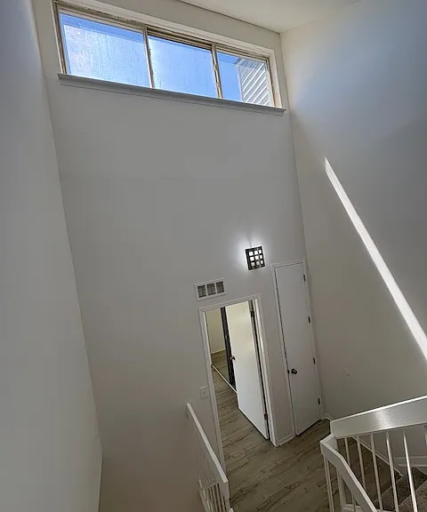 view of clear story windows on high ceiling from bedrooms