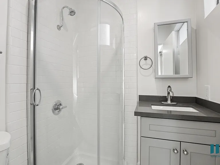 Bathroom with Stand-Up Shower and Glass Door and Vanity Cabinet Storage