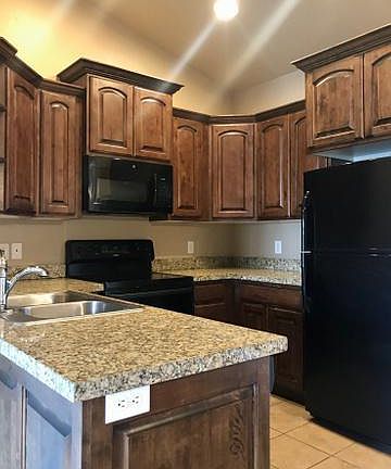 Granite counter tops, tile flooring, lots of cabinet and storage space