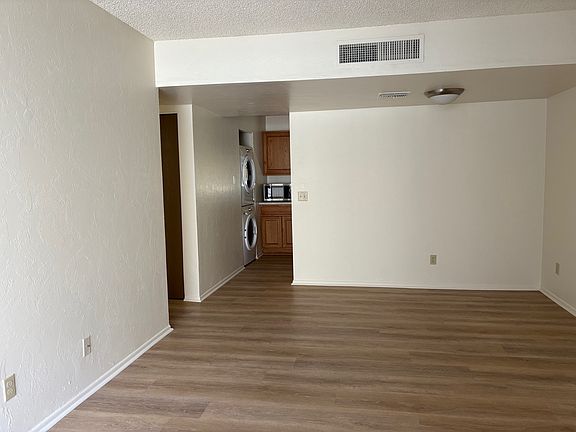 Living room, showing dining area and kitchen entry