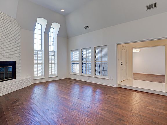 Living room with vaulted ceilings, fireplace, and wetbar.